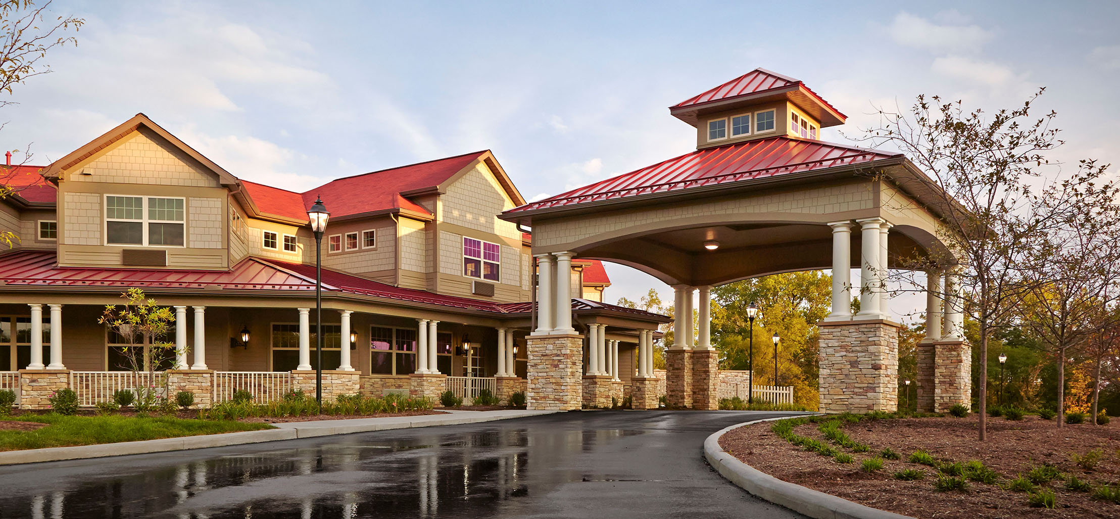 exterior of Beachwood facility with stone and a red metal roof - New Perspective Careers Assisted Living Careers