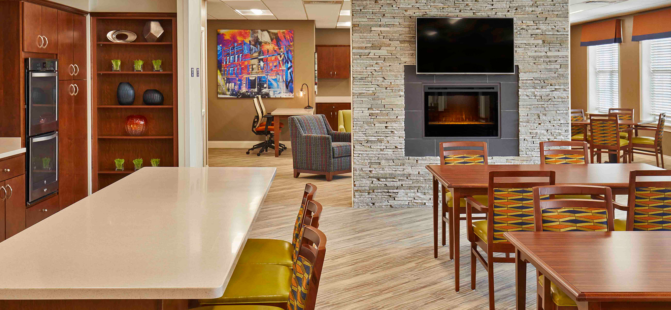 kitchen with cherry red cabinets and stone fireplace - New Perspective Careers Assisted Living Careers