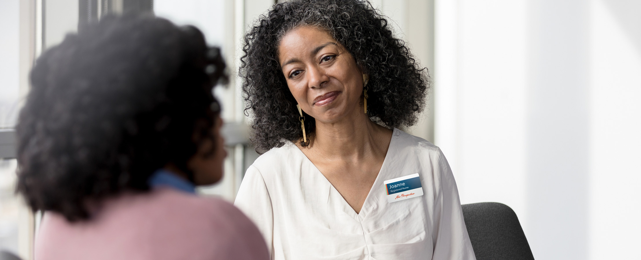 caretaker chatting with a patient - New Perspective Careers Assisted Living Careers