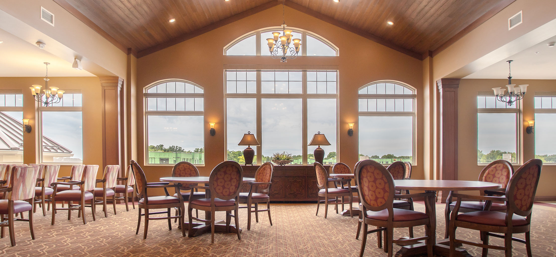 interior of facility with tables and chairs and large windows - New Perspective Careers Assisted Living Careers