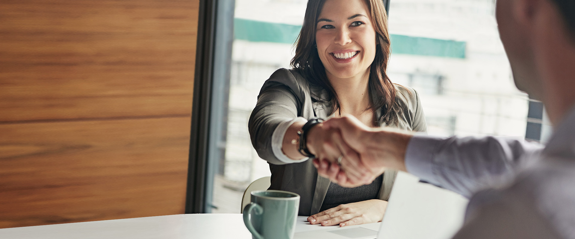 woman shaking hands with a man - New Perspective Careers Assisted Living Careers