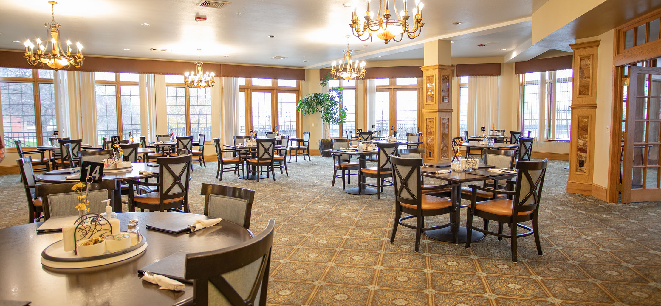 interior of facility with tables and chairs and large windows - New Perspective Careers Assisted Living Careers