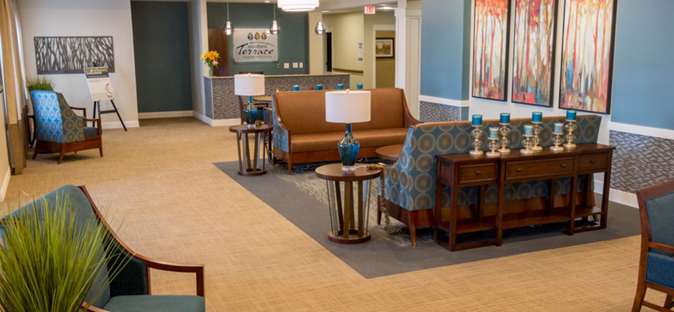 Entrance of facility with artwork and light brown couches - New Perspective Careers Assisted Living Careers