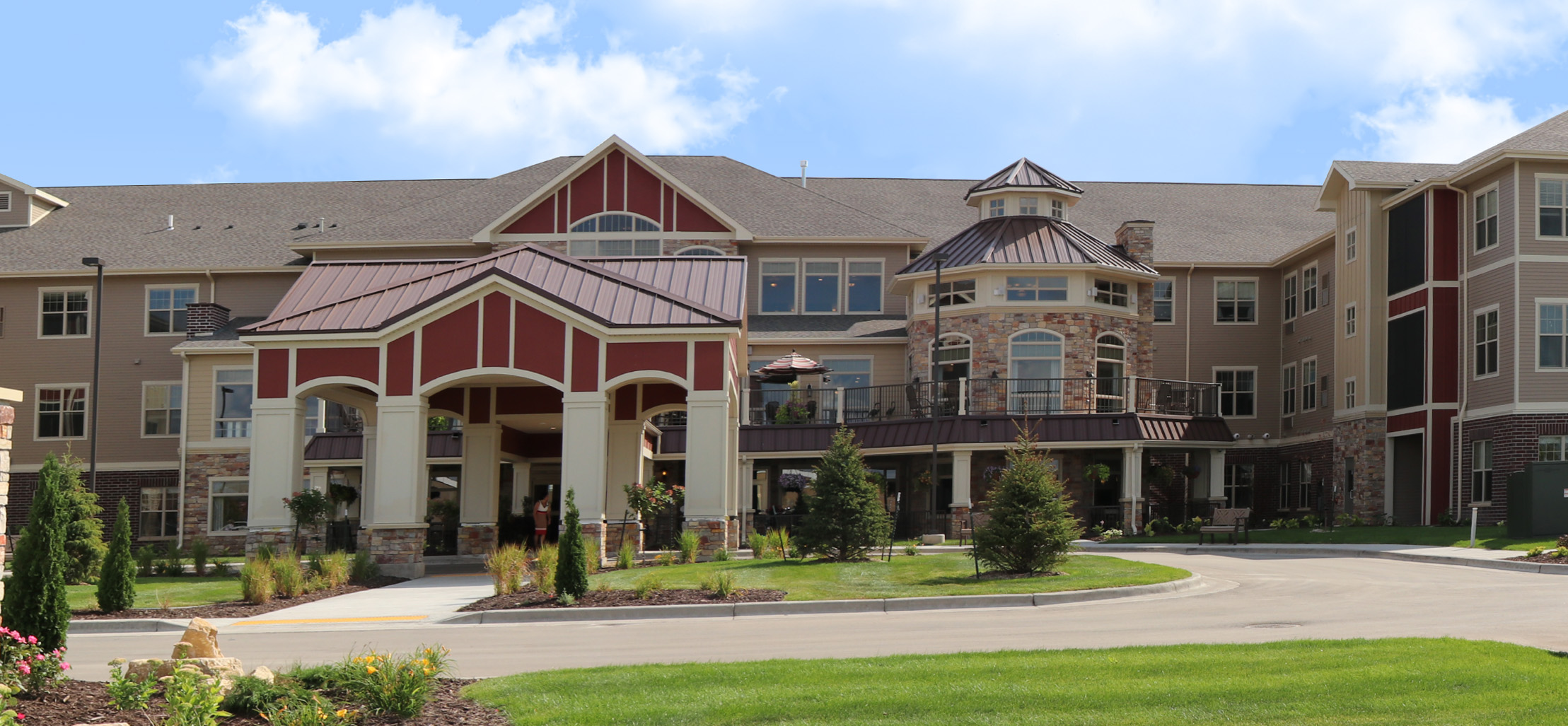 exterior of West Fargo facility with stone and dark red siding - New Perspective Careers Assisted Living Careers